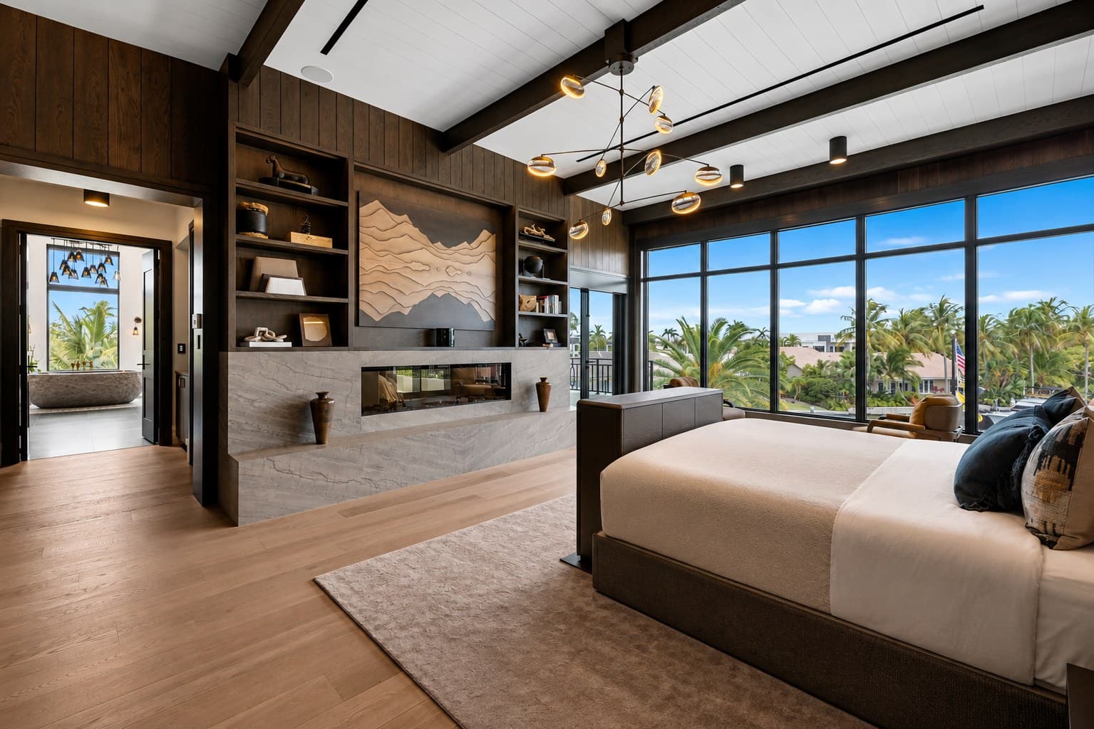 Master bedroom with wood-beam ceiling and terrace access