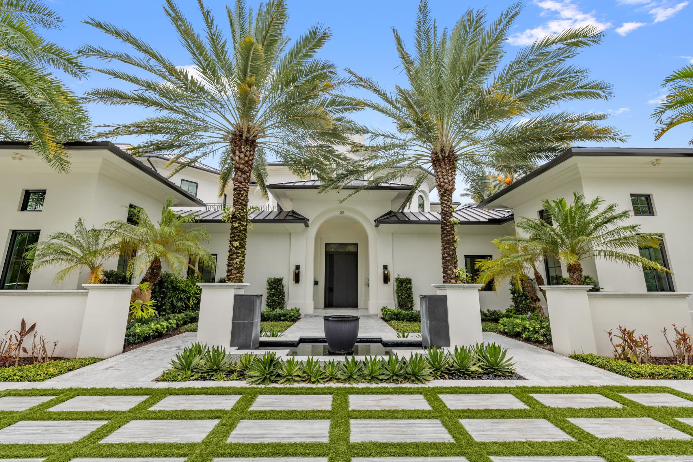 Front elevation of a modern single-story luxury home at midday