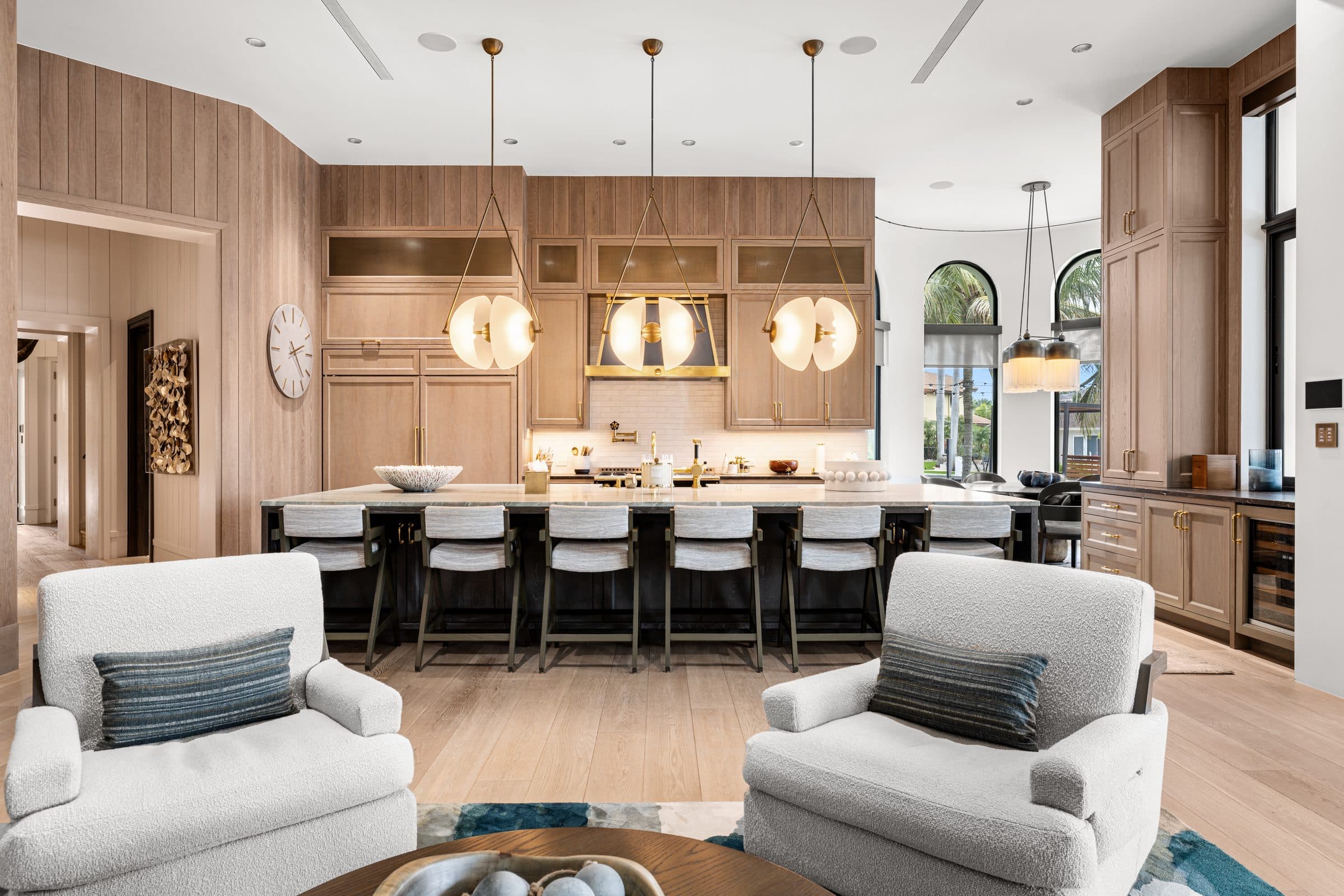 Luxury open kitchen with marble island, brass pendant lights, and hand-milled cabinetry — the architectural detail BHS preserves
